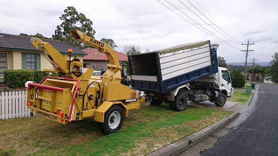 Wood chipper and tip truck on site